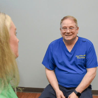 What to expect from injectables and dermal fillers 2 Dr. Evans talking to a patient, representing injectables and dermal fillers