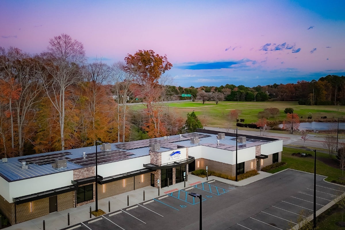 Williamsburg location 14 Front exterior view of peninsula dermatology’s williamsburg office at sunset with accessible parking spaces.