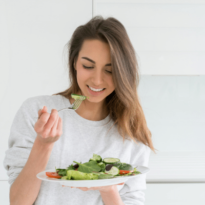 The connection between diet and skin health 2 Woman enjoying a healthy salad, representing diet and skin health